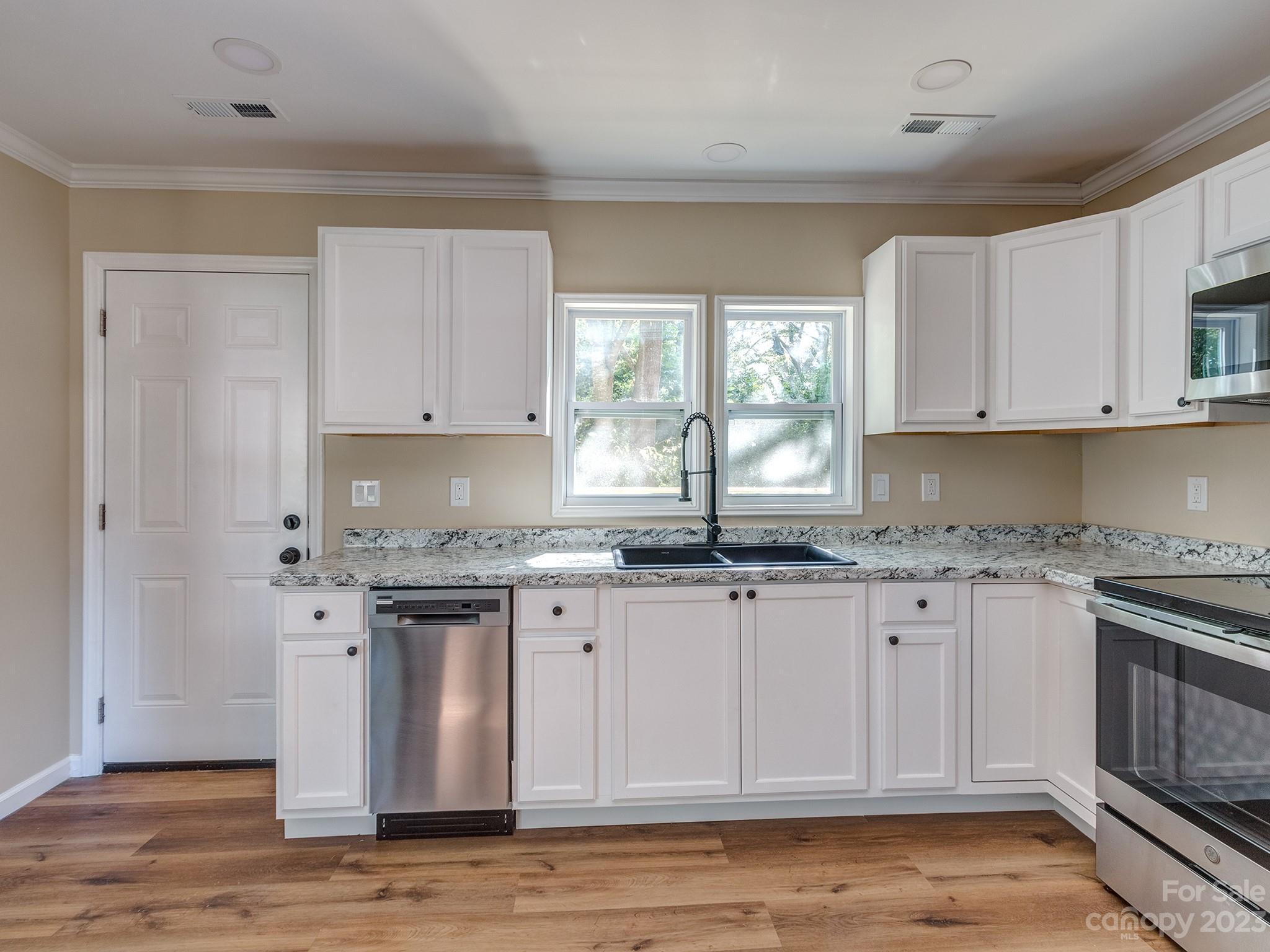 1031 State Rd S-29-424 Lancaster, SC 29720 - Photo 6 of 47 a kitchen with granite countertop a sink stove and cabinets