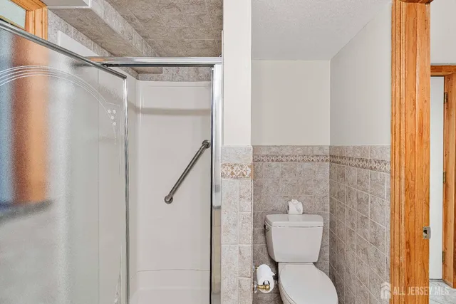 a bathroom with a toilet and a shower
