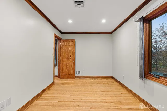 a view of room with window and wooden floor