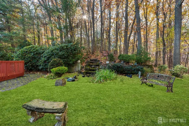 a garden with trees in front of it