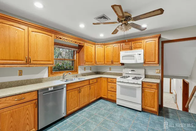 a kitchen with stainless steel appliances a stove sink and cabinets
