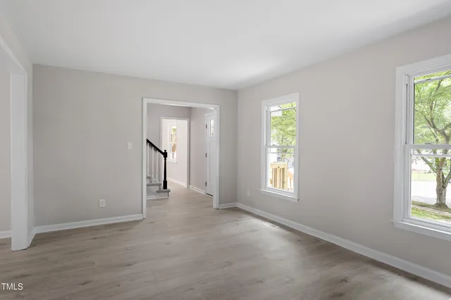 an empty room with windows and closet
