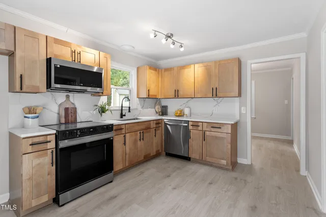 a kitchen with a sink stove and microwave