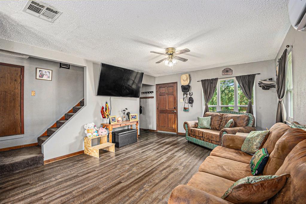 150 County 2110 Road Whitney, TX 76692 - Photo 6 of 21 a living room with furniture and a flat screen tv