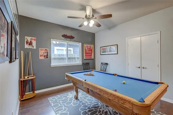 a room with pool table and a window