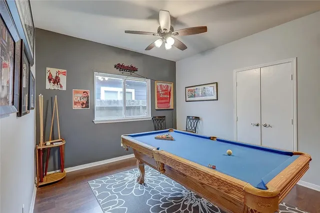 a room with pool table and a window