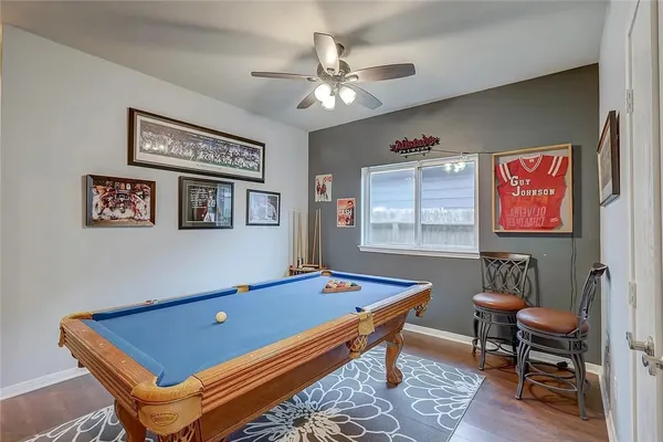 a room with furniture pool table and window
