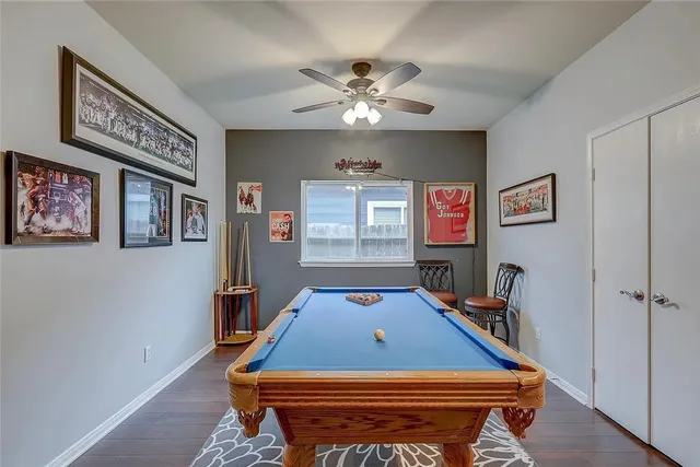 a room with pool table and windows