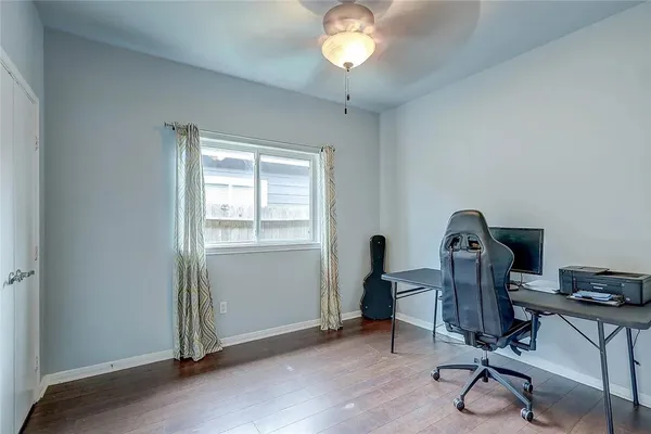 a view of a workspace with furniture and a window