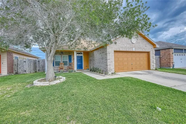 a front view of house with a garden