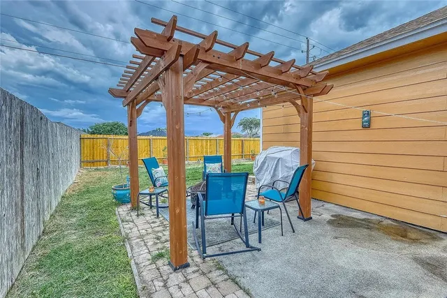 a view of a patio with table and chairs with wooden floor