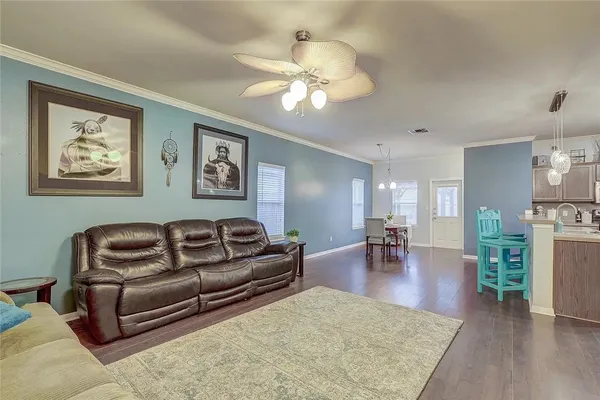 a living room with furniture and wooden floor