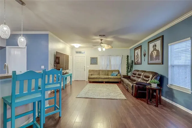 a living room with furniture and wooden floor
