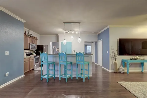 a view of a living room kitchen and a chandelier