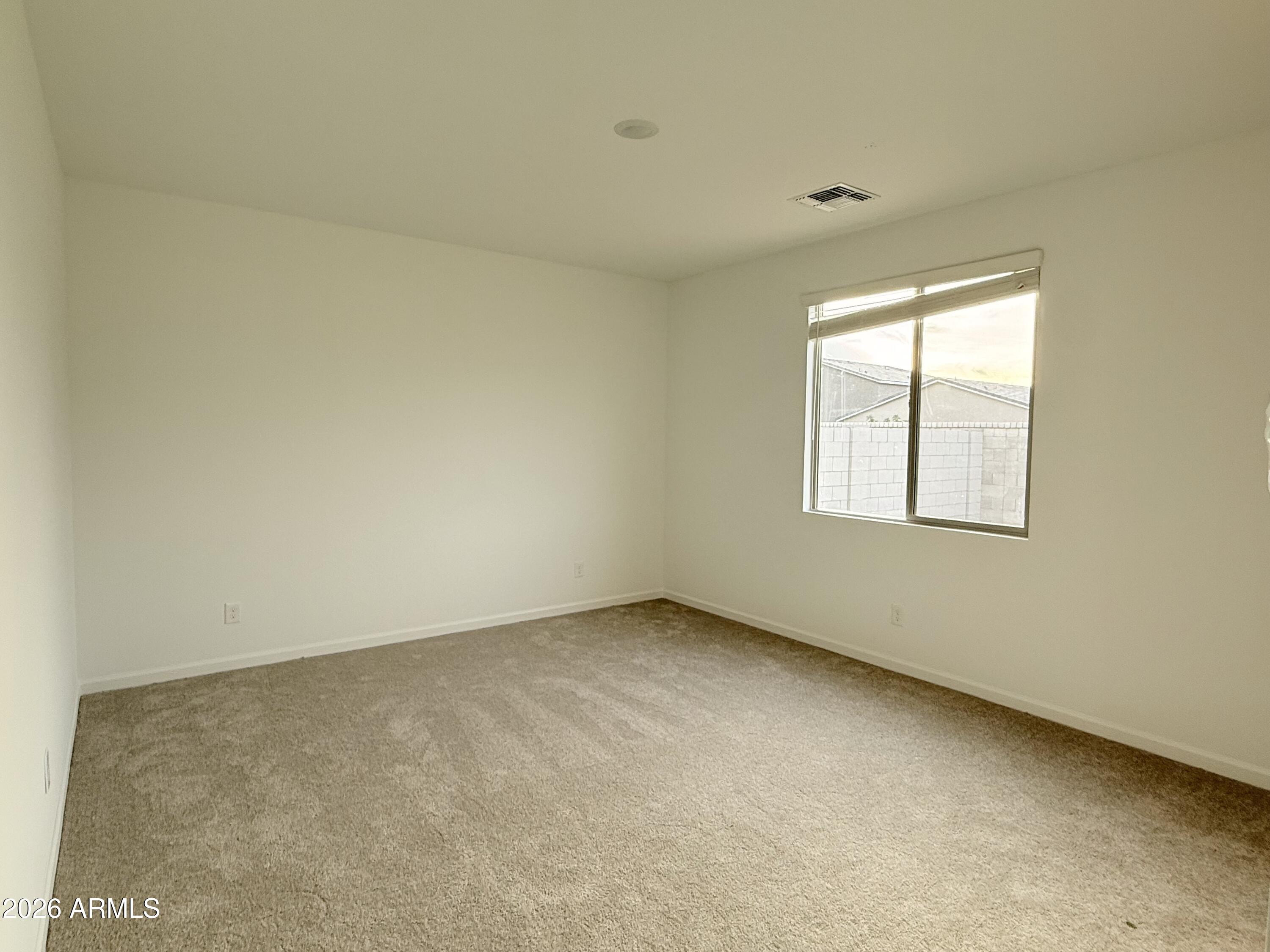 32148 Buckaroo Road San Tan Valley, AZ 85140 - Photo 12 of 45 an empty room with a window