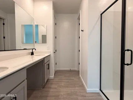 a spacious bathroom with a double vanity sink and mirror