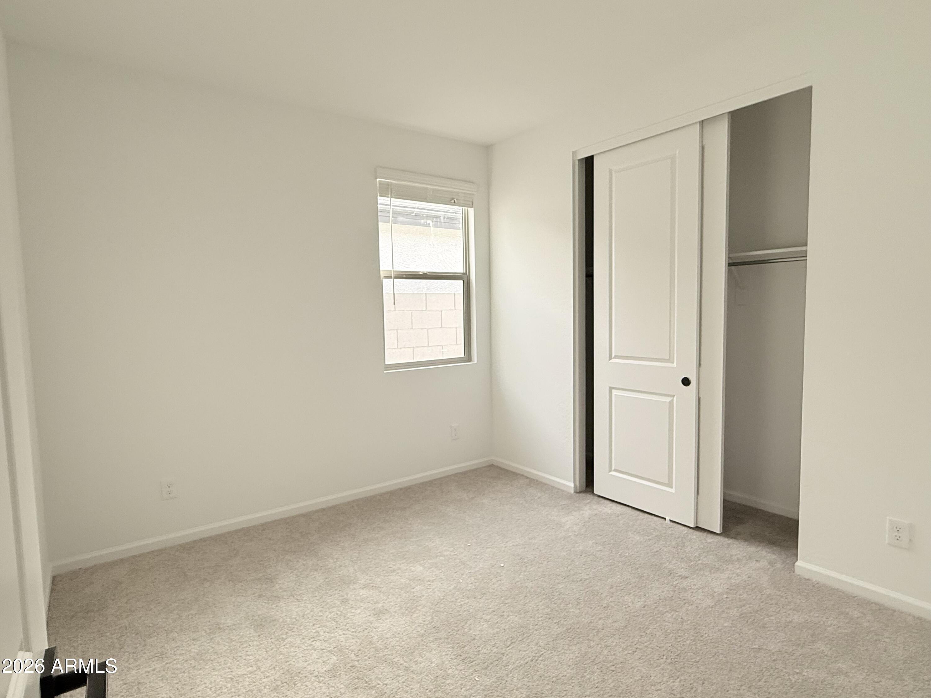 32148 Buckaroo Road San Tan Valley, AZ 85140 - Photo 15 of 45 an empty room with windows and closet