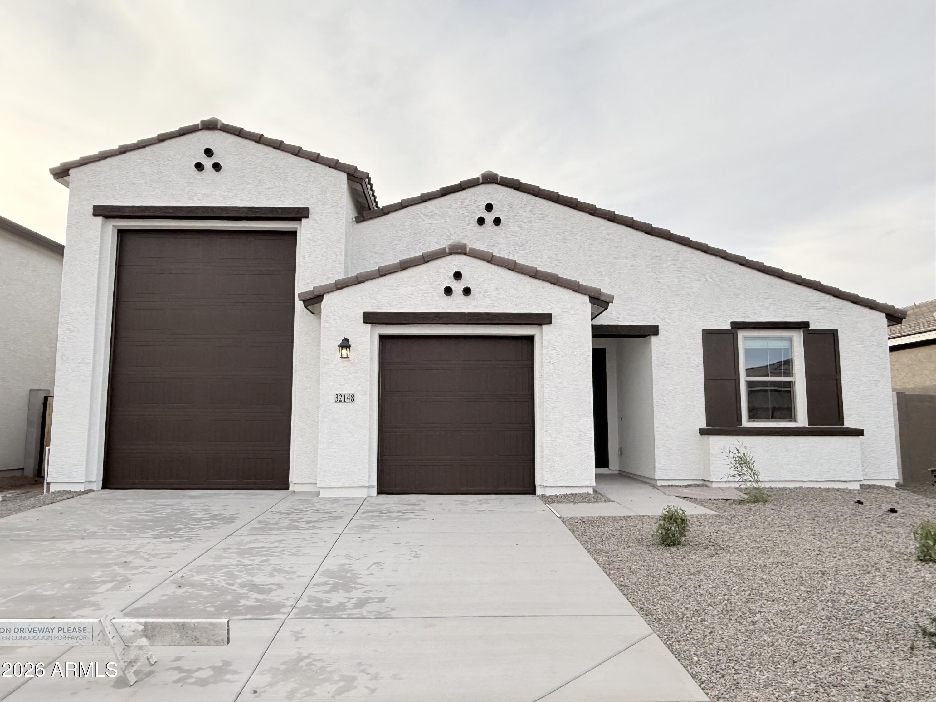 32148 Buckaroo Road San Tan Valley, AZ 85140 - Photo 2 of 45 a front view of a house with a yard