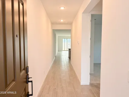 a view of a hallway with wooden floor