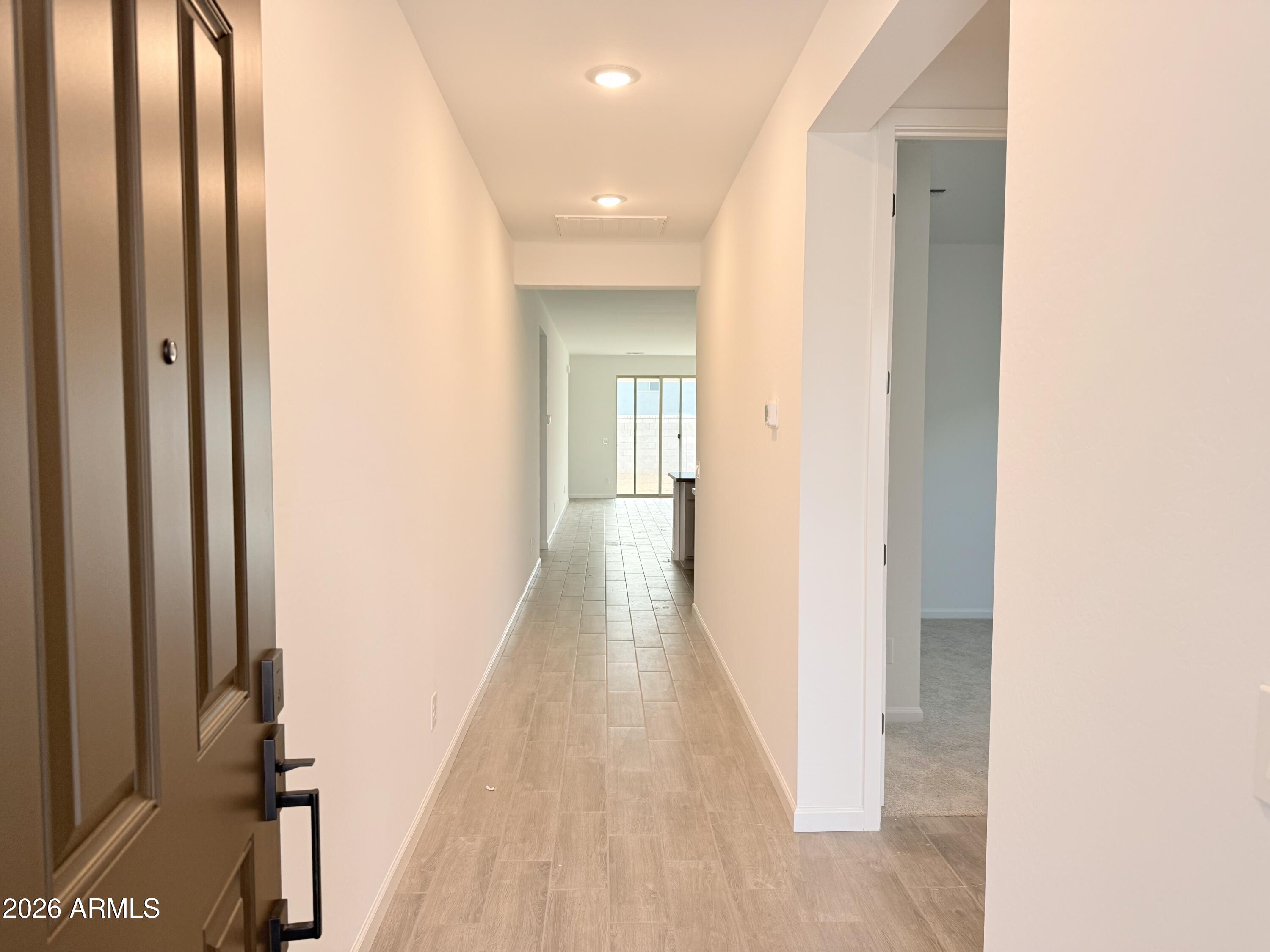32148 Buckaroo Road San Tan Valley, AZ 85140 - Photo 4 of 45 a view of a hallway with wooden floor
