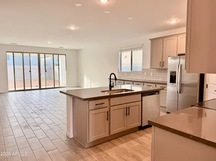 a kitchen with stainless steel appliances granite countertop a sink and a stove top oven
