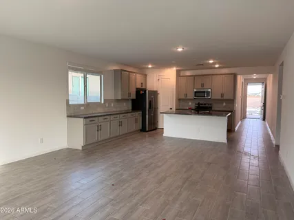 a view of a kitchen with a sink cabinets and wooden floor