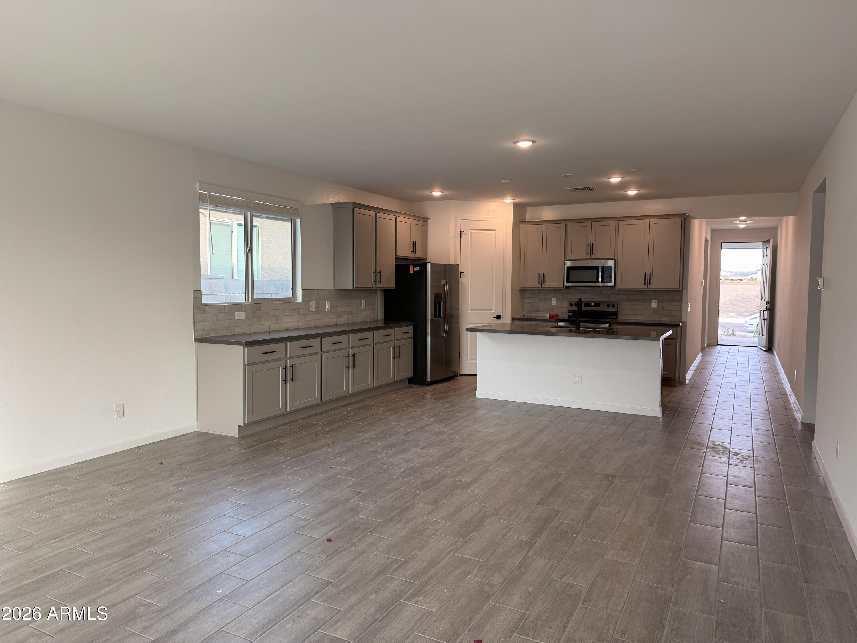 32148 Buckaroo Road San Tan Valley, AZ 85140 - Photo 9 of 45 a view of a kitchen with a sink cabinets and wooden floor