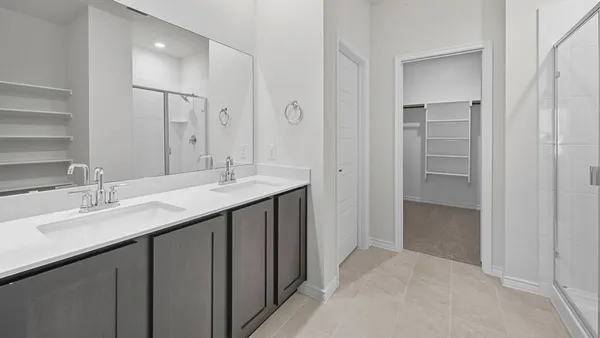a bathroom with a double vanity sink and mirror