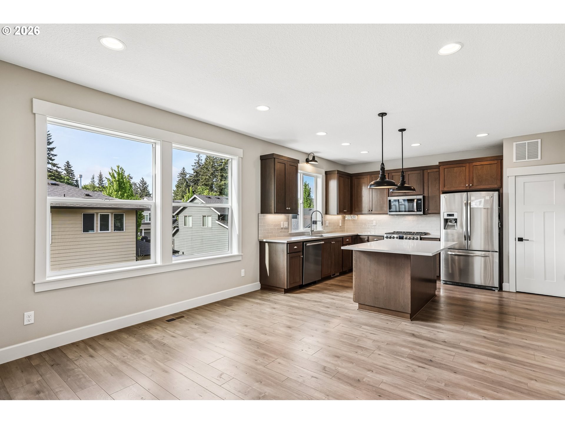 38320 Sequoia Street Sandy, OR 97055 - Photo 8 of 33 a large white kitchen with a large window and stainless steel appliances