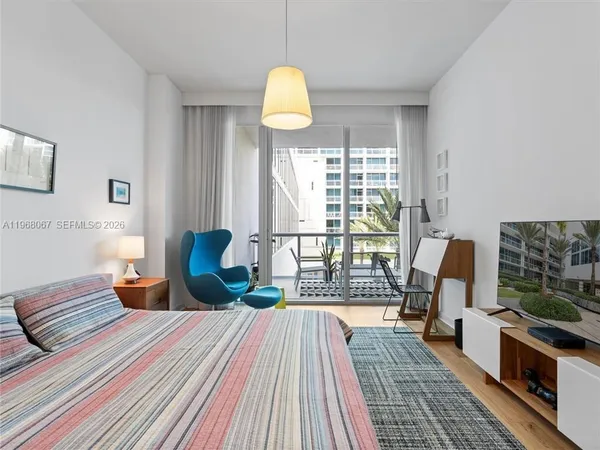 a bedroom with a bed and large window