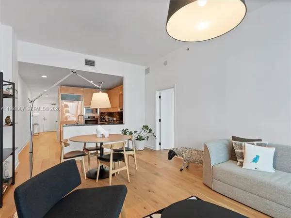 a living room with furniture a large window and a table