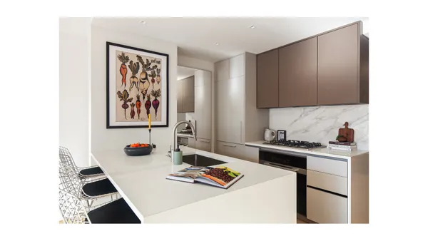a kitchen with stainless steel appliances a stove a sink a refrigerator white walls and cabinets