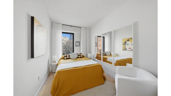 a hallway with a large window and a white walls