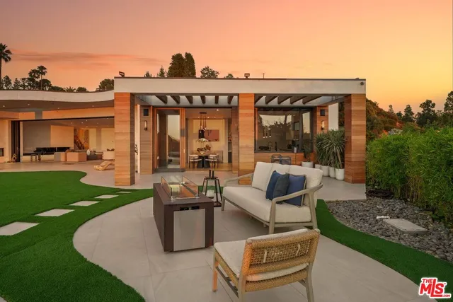 a view of a patio with couches chairs and a yard