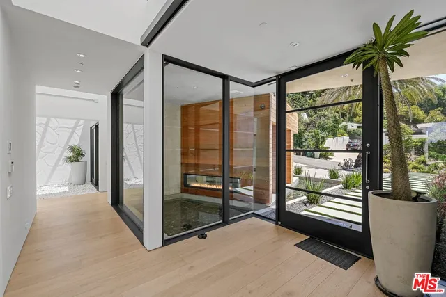 a living room with patio furniture and a large window