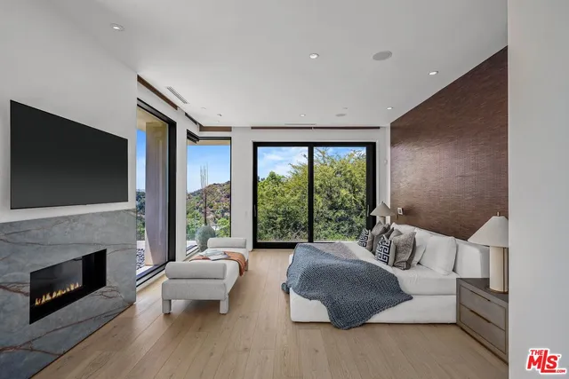 a living room with fireplace furniture and a floor to ceiling window