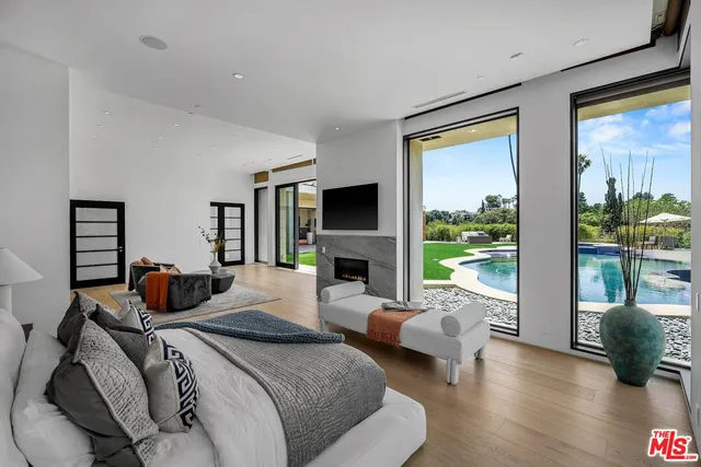 a view of a hallway with wooden floor and entryway