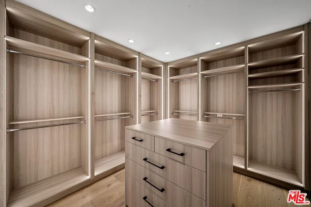 a living room with furniture a flat screen tv and a floor to ceiling window