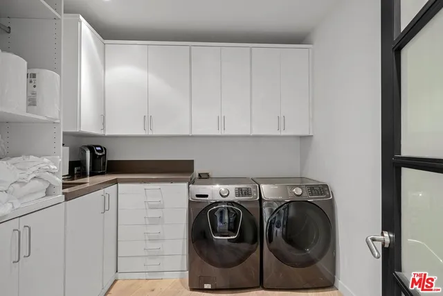 a bedroom with bed and glass window