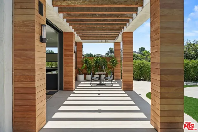 a aerial view of a house with swimming pool and sitting area