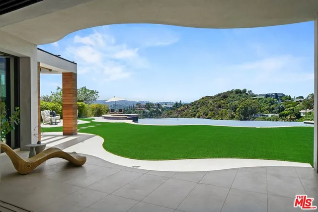 a view of a house with swimming pool yard and outdoor seating