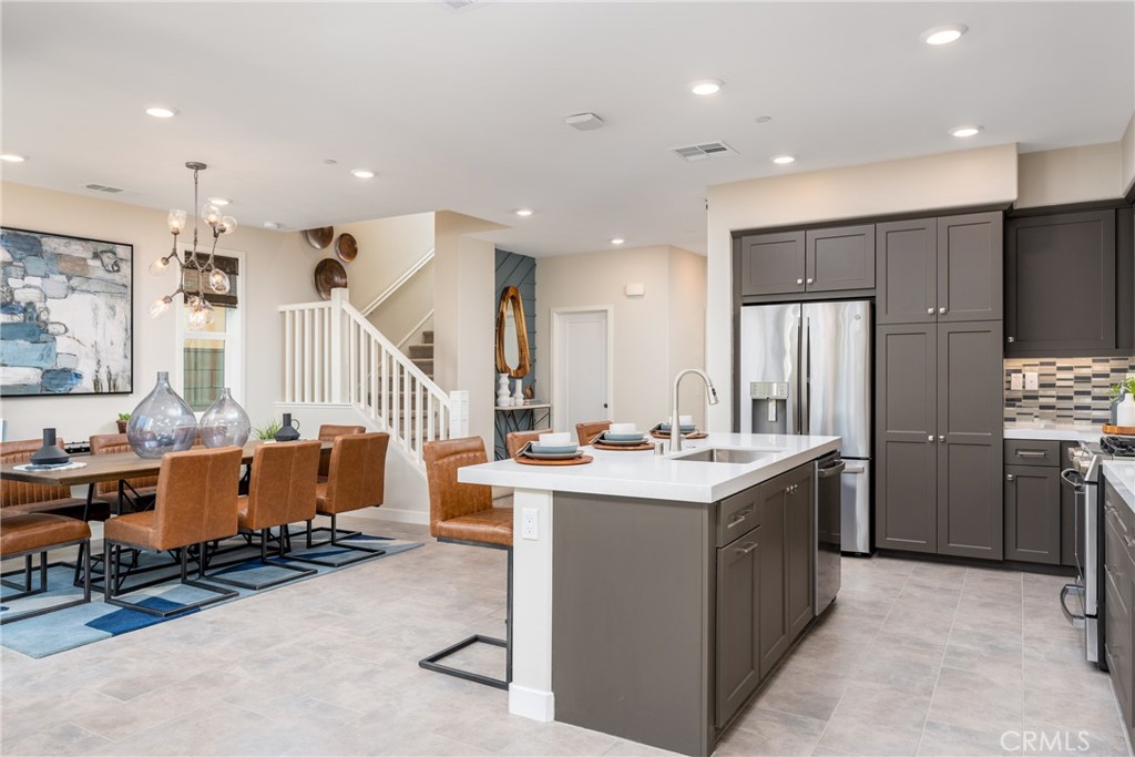 263 Siena Lake Forest, CA 92630 - Photo 3 of 51 a room with stainless steel appliances kitchen island granite countertop a refrigerator and a sink