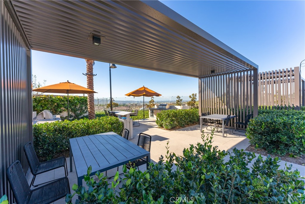 263 Siena Lake Forest, CA 92630 - Photo 45 of 51 a view of a patio with table and chairs under an umbrella