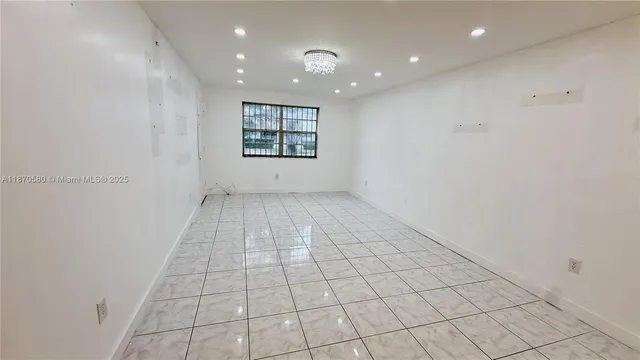 an empty room with white walls and tiles