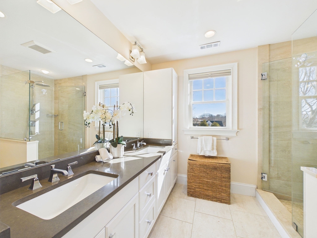 36 Troy Lane Newton, MA 02468 - Photo 18 of 42 a spacious bathroom with a double vanity sink a mirror and a shower