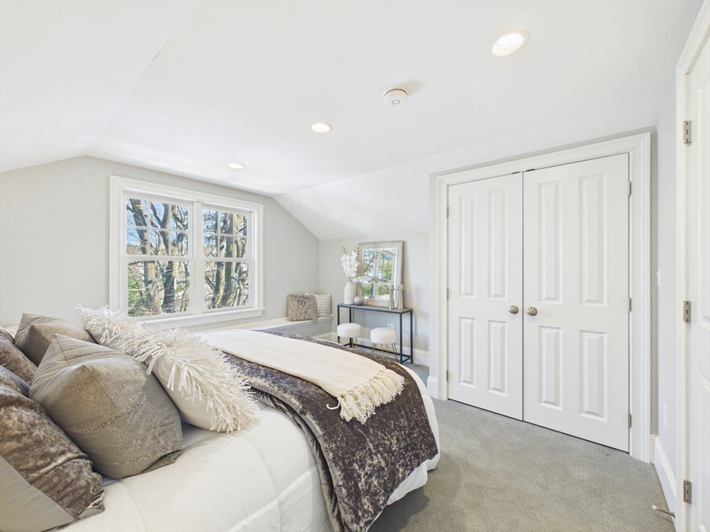 36 Troy Lane Newton, MA 02468 - Photo 24 of 42 a bedroom with a large bed and a window