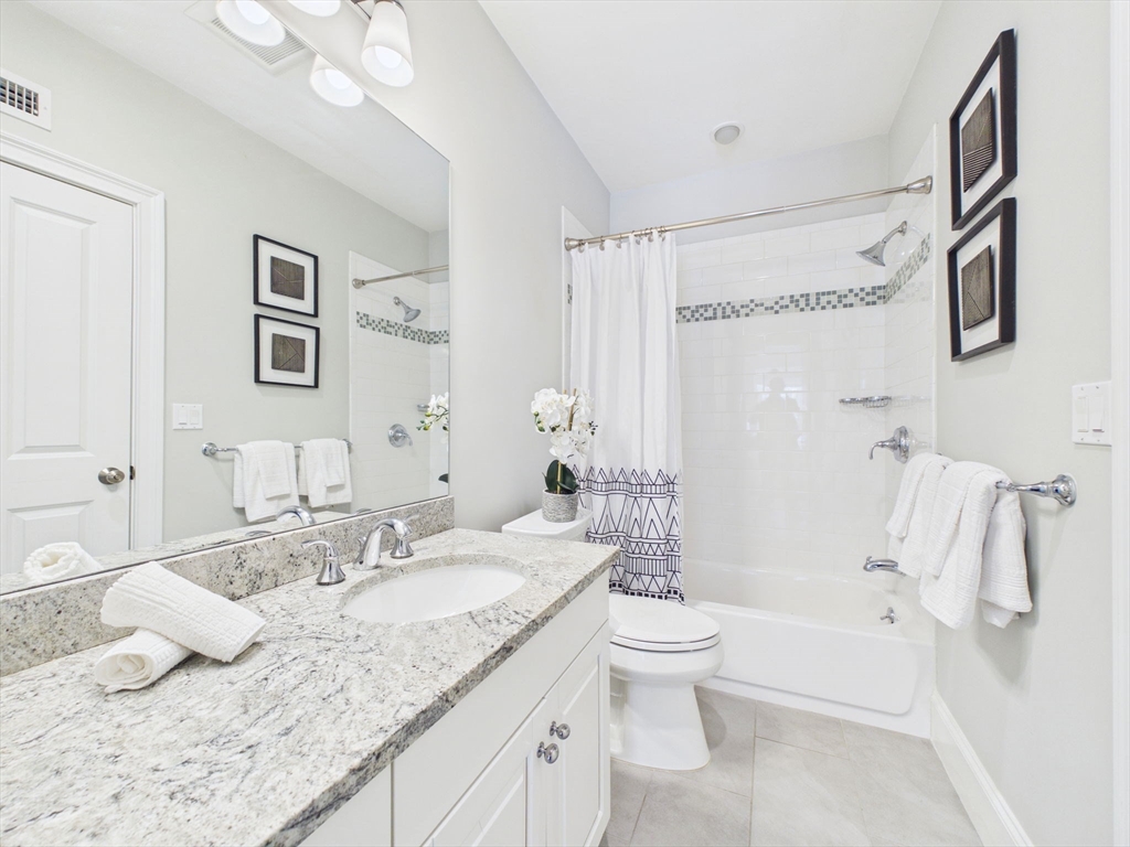 36 Troy Lane Newton, MA 02468 - Photo 32 of 42 a bathroom with a granite countertop sink and a mirror