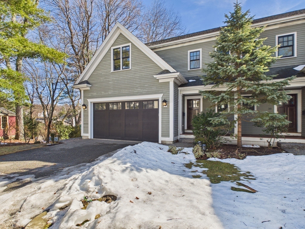 36 Troy Lane Newton, MA 02468 - Photo 37 of 42 a front view of a house with a yard and garage