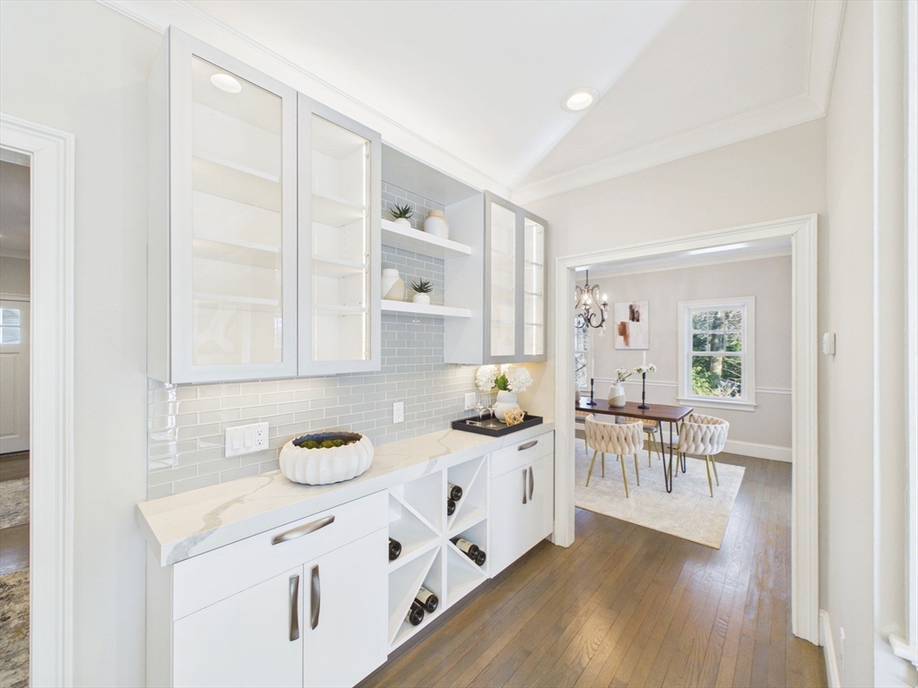 36 Troy Lane Newton, MA 02468 - Photo 9 of 42 a kitchen with white cabinets and wooden floor
