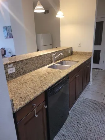 a bathroom with a granite countertop sink a vanity and a mirror